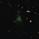 Lyman-alpha blob (LAB-1) pictured at the center is one of the largest known objects in the universe. Because of its distance, the blob’s UV emissions get stretched on their journey through space and appear green to our telescopes. Image: ESO/M. Hayes